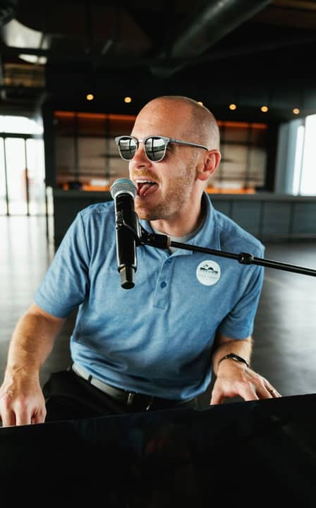 close-up of greg playing the piano and singing
