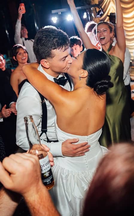 bride and groom kissing at reception